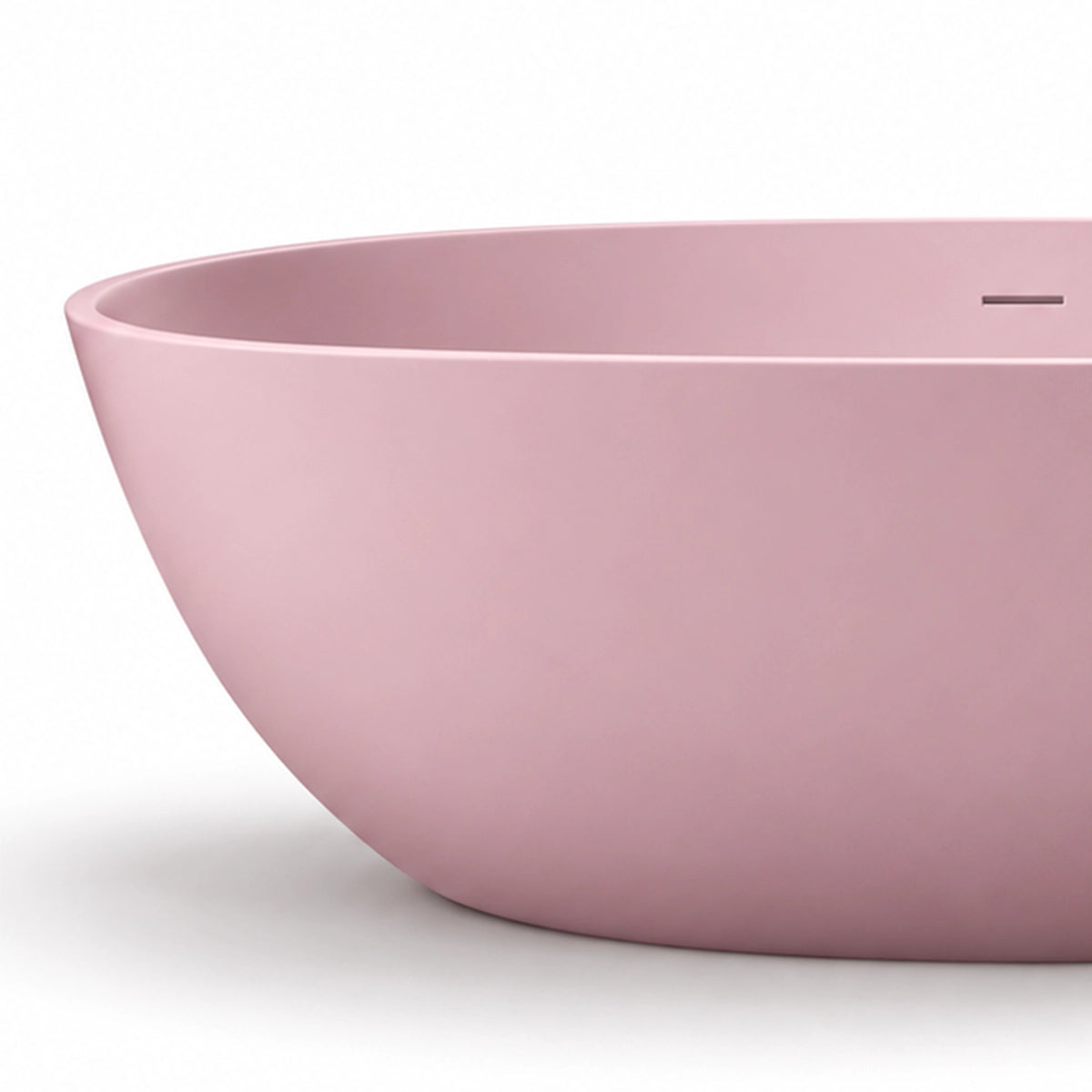 Close-up of matte pink bathtub rim, showing seamless wall and built-in overflow