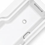Close-up of bathtub interior with two built-in metal grab bars and central drain, featuring smooth rounded corners