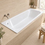 Drop-in bathtub placed in sunlit bathroom with wooden stool, full stone tile wall finish for clean minimalist space