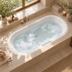 Drop-in oval acrylic tub in bathroom with wooden frame window, candles and green plants on counter for warm bathroom scene