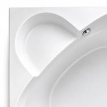 Close-up of built-in tub backrest, seamless molded glossy acrylic surface with polished metal overflow fitting