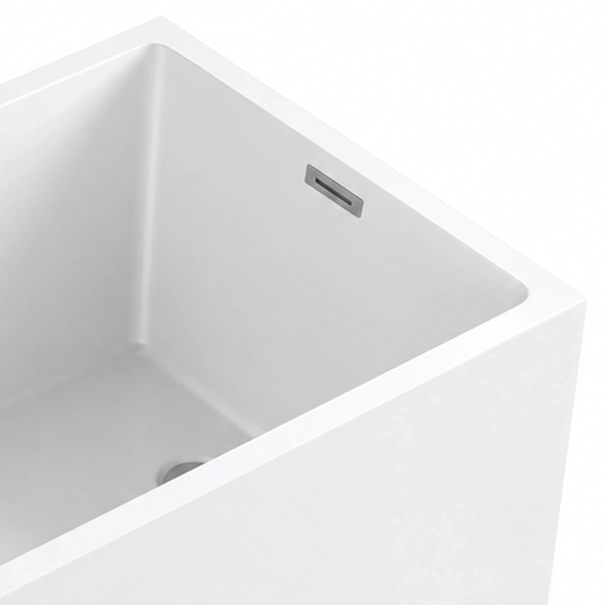 Close-up of bathtub inner corner, thin tub rim and built-in metal overflow, straight inner wall