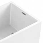 Close-up of bathtub inner corner, thin tub rim and built-in metal overflow, straight inner wall