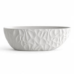 Freestanding oval bathtub, white finish with continuous 3D wavy relief texture on exterior