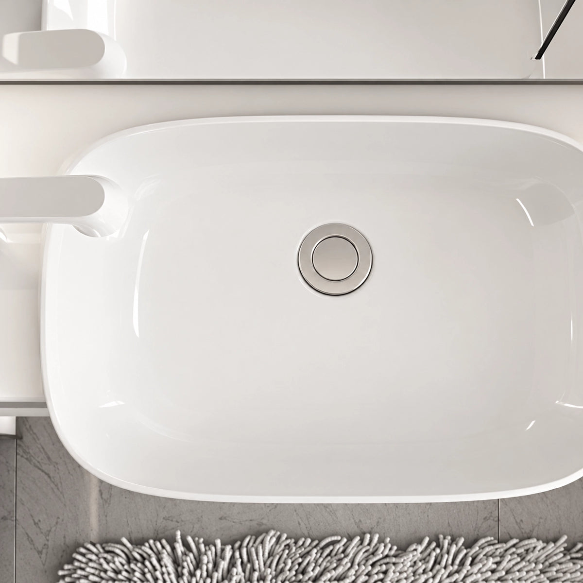 Top view of glossy ceramic sink basin and drain hole