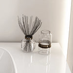 Glossy countertop surface with glass aromatherapy bottles