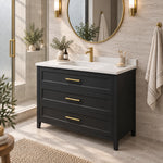 3‑drawer freestanding bathroom vanity, partial close‑up bathroom view, gold‑framed round mirror, side glass shower partition