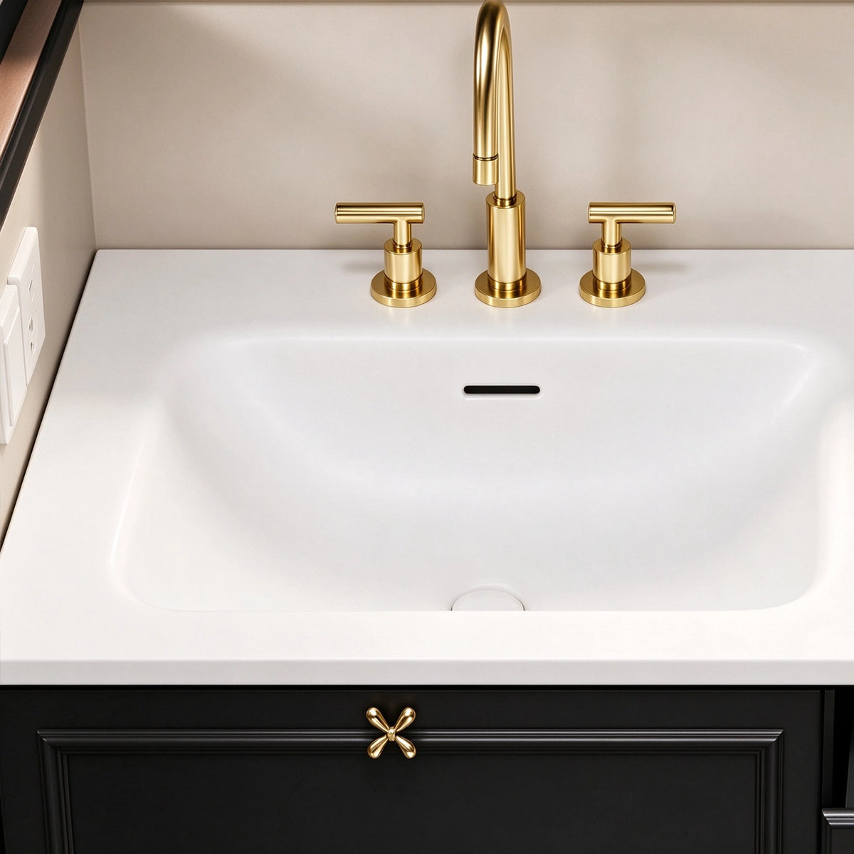 Close‑up of sink & faucet, integrated white sink, 3‑hole gold faucet, bow‑knot style gold cabinet pull