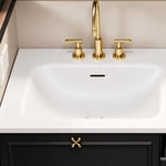 Close‑up of sink & faucet, integrated white sink, 3‑hole gold faucet, bow‑knot style gold cabinet pull