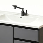Close‑up of swivel faucet and ceramic sink basin