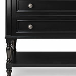 Partial lower cabinet view, double recessed‑panel drawers, turned decorative legs, open black storage shelf