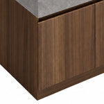 Close‑up of stone countertop, undermount sink and black faucet