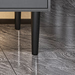 Close‑up of tapered black solid cabinet leg