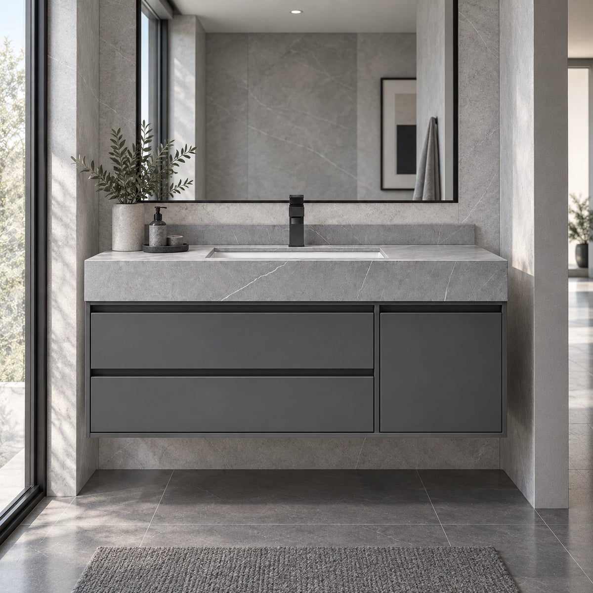 Dark gray floating vanity installed in modern stone bathroom
