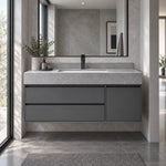 Dark gray floating vanity installed in modern stone bathroom