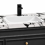 Vanity close‑up, Bulgari marble top with square black faucet