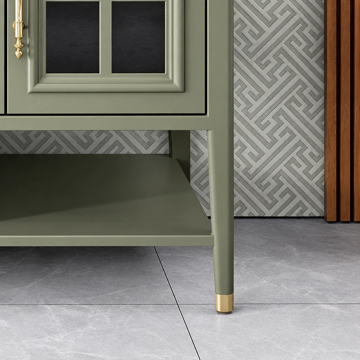 Vanity leg detail, slim green frame with gold ferrule, grey tile flooring