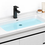 Sink close‑up, water‑filled white ceramic basin with black square faucet