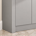 Corner vanity cabinet close‑up, light gray matte door panel with neat edge trimming