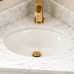 Sink and faucet detail, marble countertop with oval ceramic basin & gold faucet