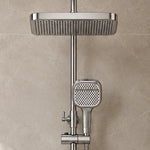 Static close‑up of square rain shower head and handheld sprayer