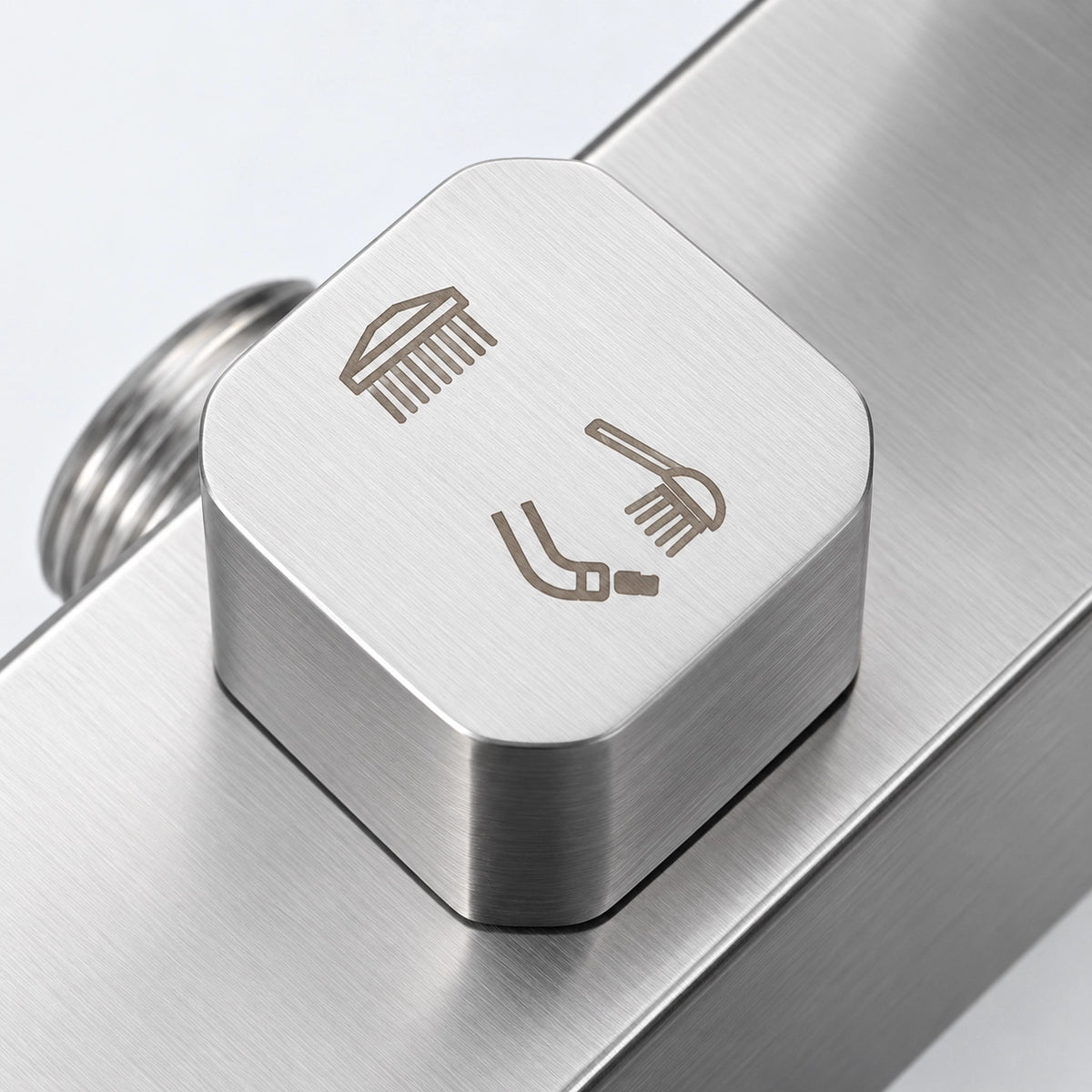 Close‑up of shower diverter knob with 3‑function water outlet icons