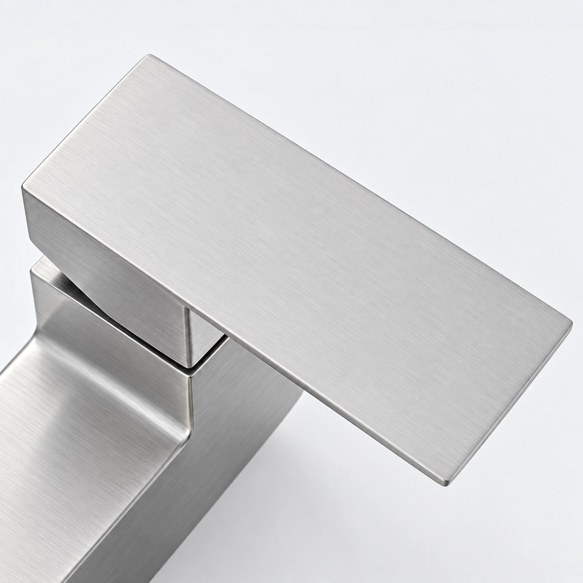 Close‑up of square shower faucet handle with fine surface finish