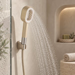 Beige filtered handheld shower in spray mode, minimalist shower area