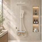 Cream 4‑function shower set, bathroom with herringbone tiled wall