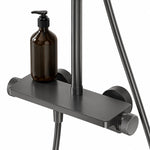 Close‑up shower shelf holding bath bottle, gunmetal finish