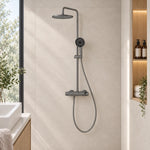 Gunmetal round shower set in bright bathroom with built‑in niche