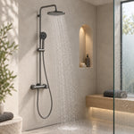 Exposed gunmetal shower kit inside glass shower enclosure with arched niche