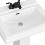 Close-up detail shot of glossy white ceramic pedestal sink basin with black faucet and silver drain