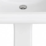 Extreme close-up of polished silver sink drain on glossy white ceramic pedestal sink