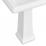 Close-up detail of glossy white ceramic pedestal sink pedestal base with decorative stepped moulding
