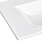 Close-up of glossy white ceramic bathroom sink, smooth surface detail