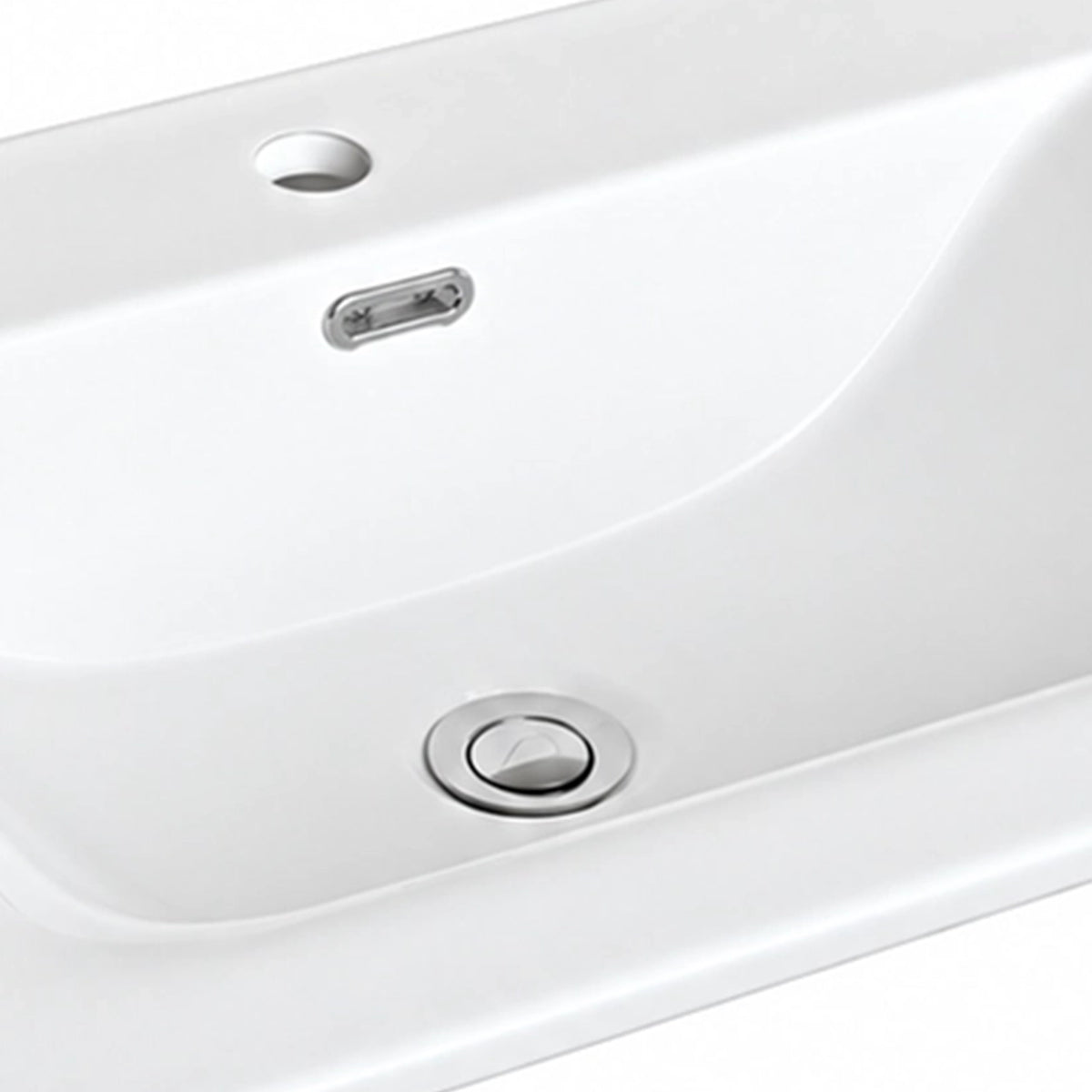 Close-up of white ceramic sink with overflow hole and drain detail