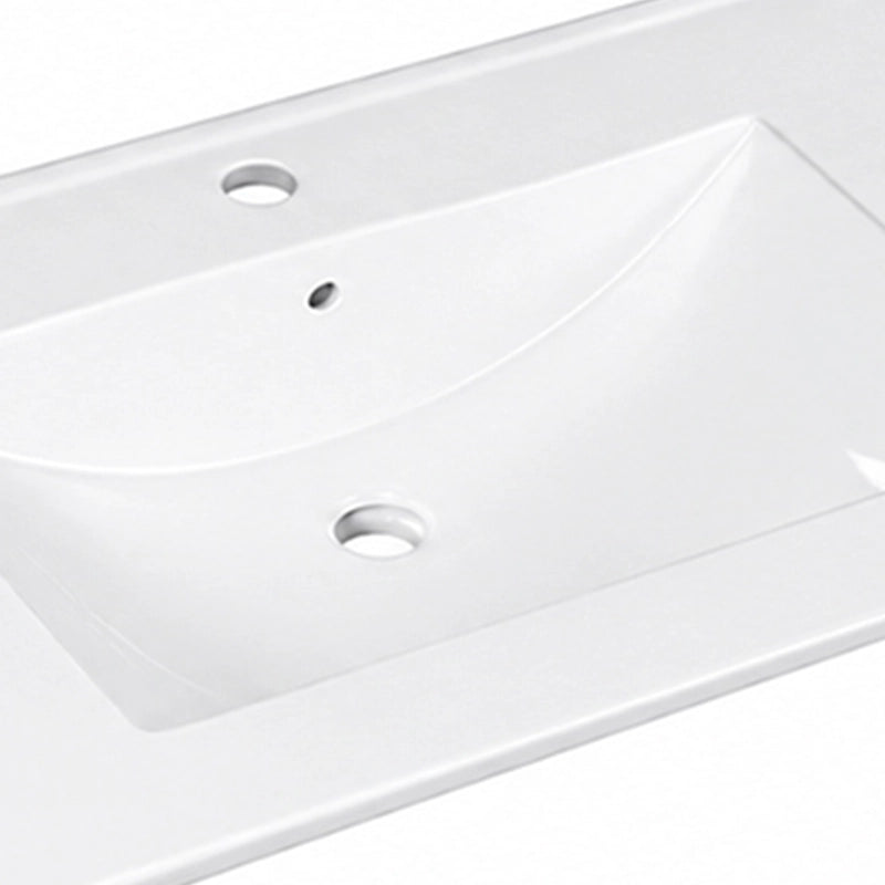 Close-up detail shot of white integrated ceramic vanity sink surface