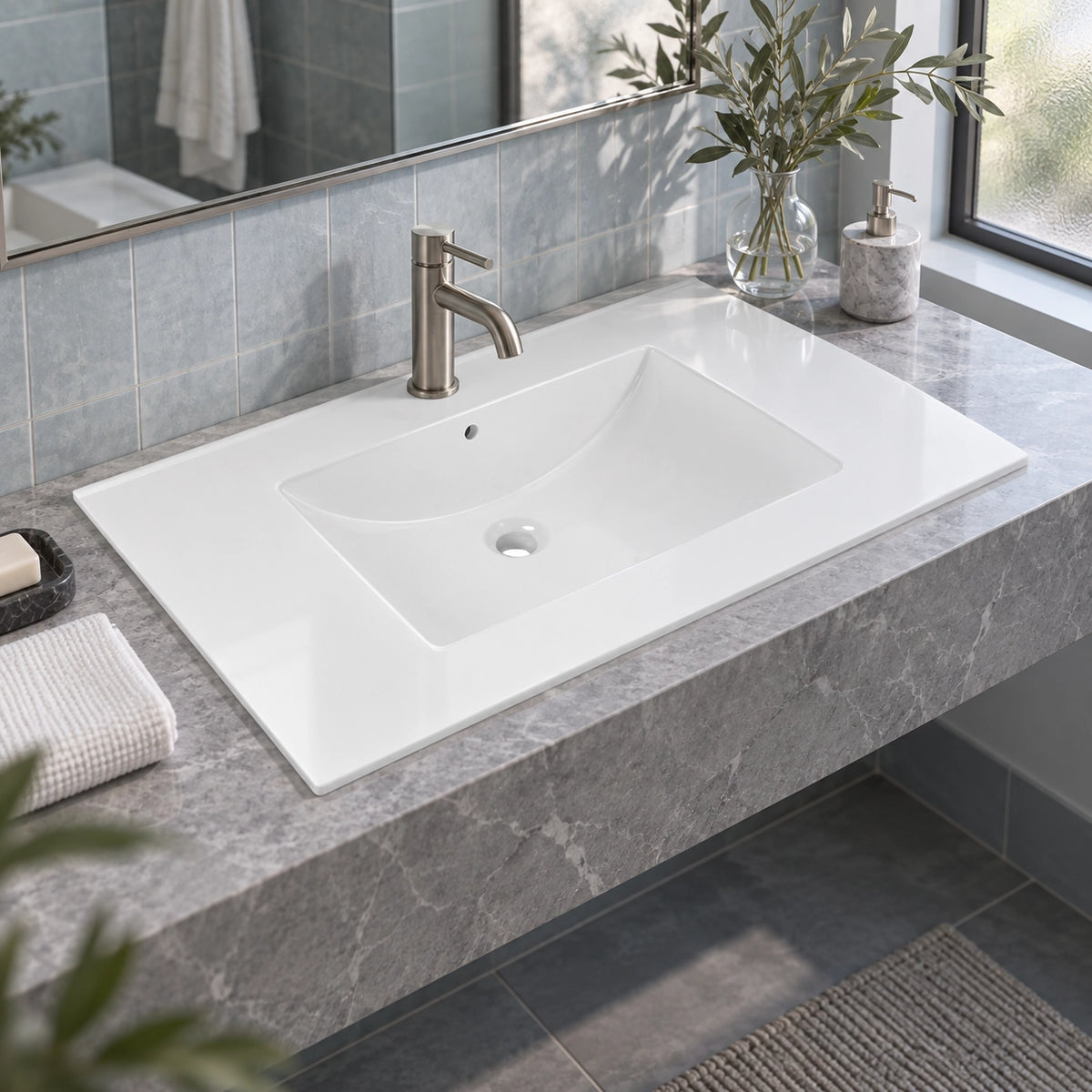 Bright tiled bathroom with white integrated vanity sink, grey marble countertop and brushed nickel faucet