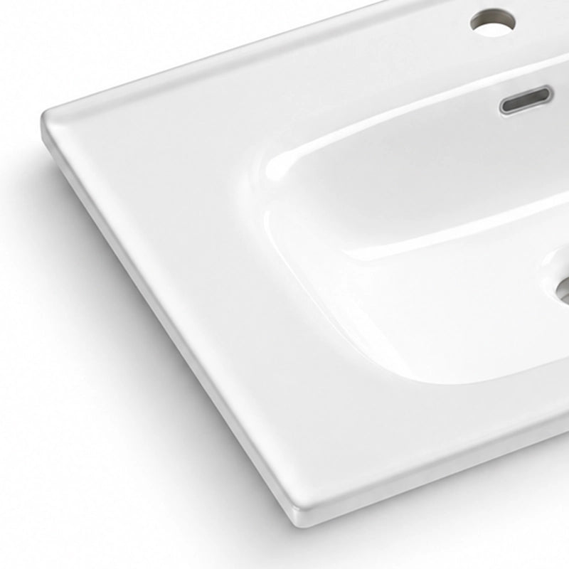 Glossy white ceramic bathroom sink close-up, smooth surface with overflow hole and faucet pre-drilled hole