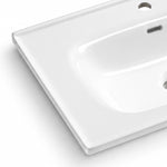 Glossy white ceramic bathroom sink close-up, smooth surface with overflow hole and faucet pre-drilled hole
