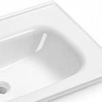 Glossy white ceramic vanity sink close-up, smooth curved basin surface with drain hole
