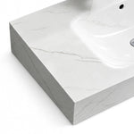 Close-up view of Fish Maw White sintered stone surface and thick edge of wall-mount bathroom sink