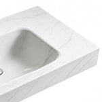 Close-up of Fish Maw White sintered stone wall-mount sink showing seamless basin and veined surface texture