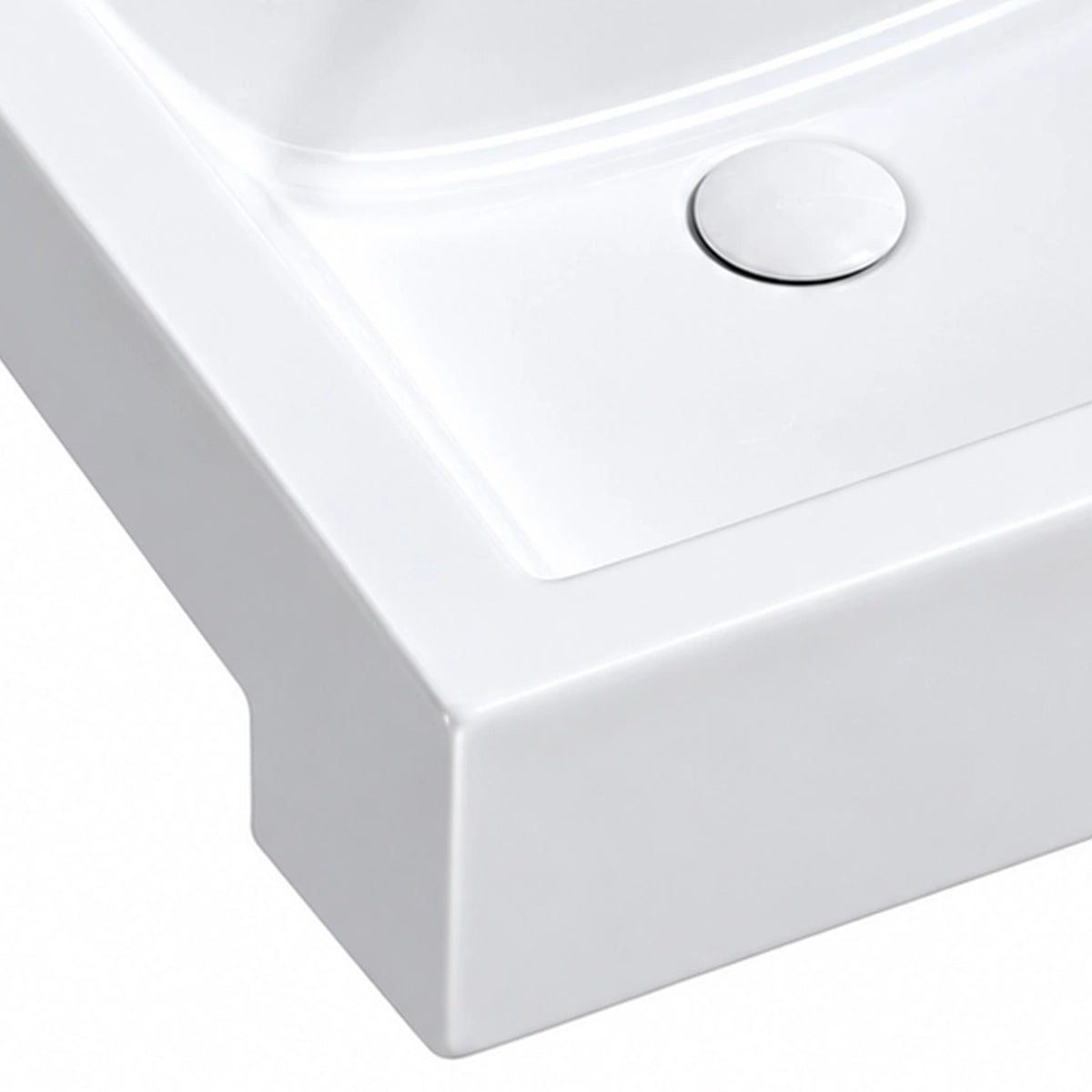Close-up of the white ceramic semi-recessed bathroom sink showing the smooth basin surface, integrated drain cover, and rounded front edge.