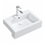 White rectangular ceramic semi-recessed bathroom sink with chrome faucet, three-quarter view