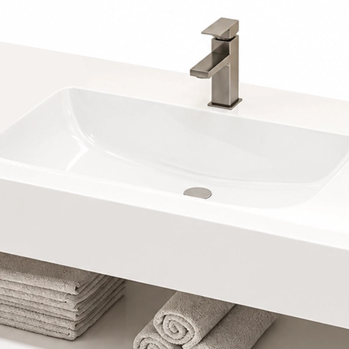 Close-up view of integrated white sink basin and modern faucet on floating bathroom vanity