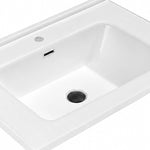 White ceramic rectangular undermount sink interior closeup with overflow and drain
