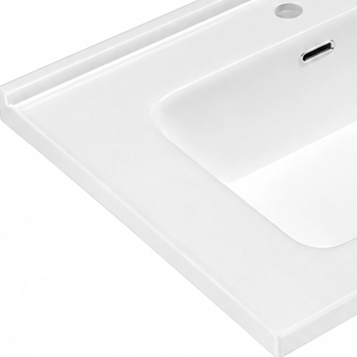 White ceramic rectangular undermount sink rim and overflow closeup