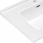 White ceramic rectangular undermount sink rim and overflow closeup